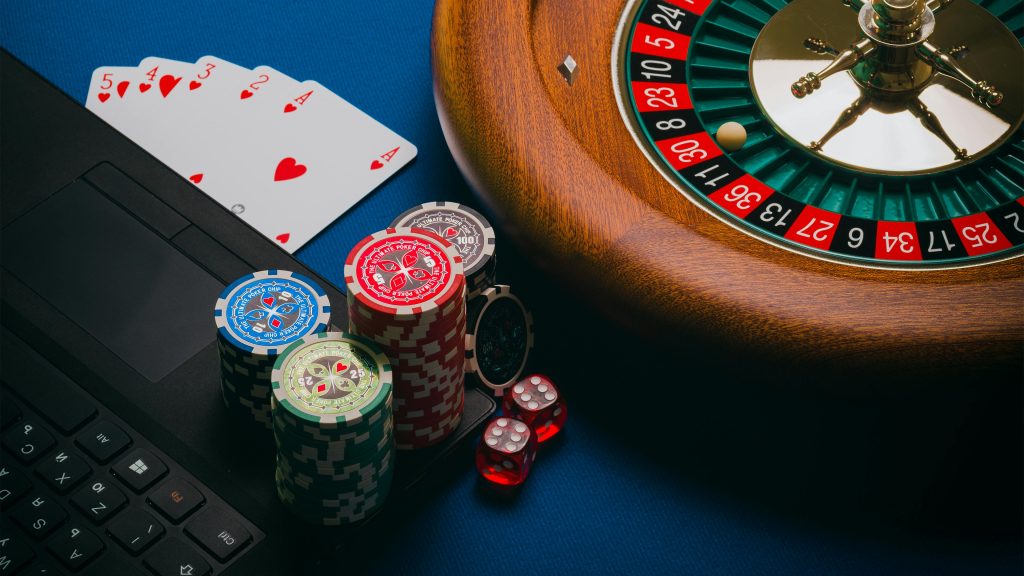 Image of a set of poker cards, chips and roulette