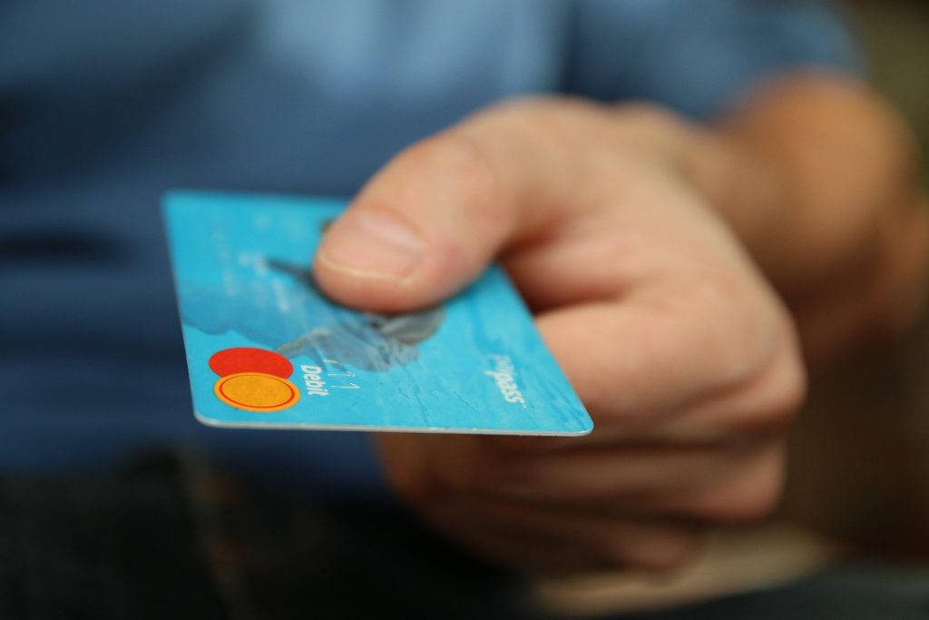 Image of a person holding a credit card